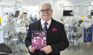 Professor Steve Creanor with copies of his new book Essential Clinical Oral Biology