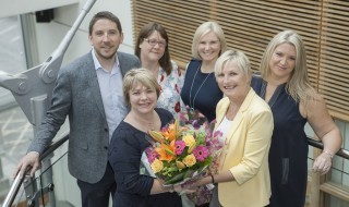 Wendy Smith from the community engagement team receives a bouquet from Professor Liz Kay, with Robert Witton, Karen Burns, Nicola Brown and Claire Kenyon